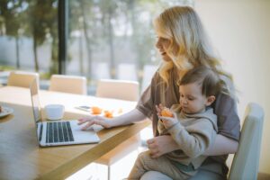 business women at computer working with baby
